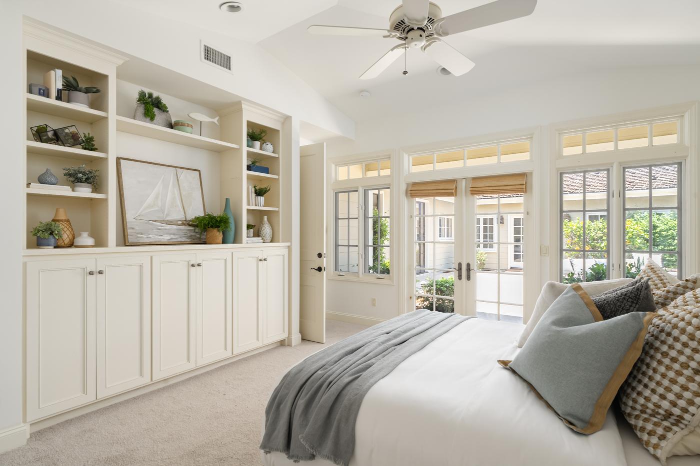 Home staging La Jolla bedroom built-in shelving French doors