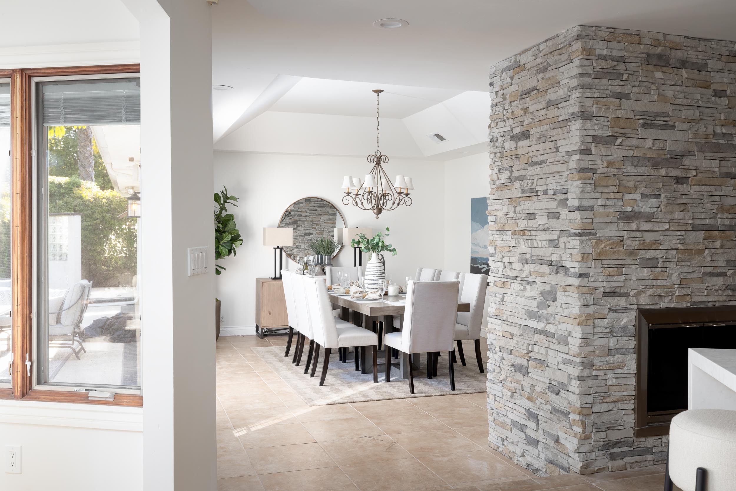 Staged formal dining room stone fireplace Poway